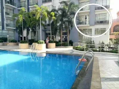 a swimming pool in front of a building at Condo Apartment near Manila Airport NAIA T3 in Manila