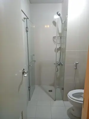 a bathroom with a shower and a toilet at Condo Apartment near Manila Airport NAIA T3 in Manila