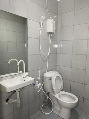 a bathroom with a shower and a toilet and a sink at DG Budget Hotel Salem in Manila