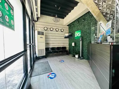 a room with a bar with a dog on the floor at DG Budget Hotel Salem in Manila