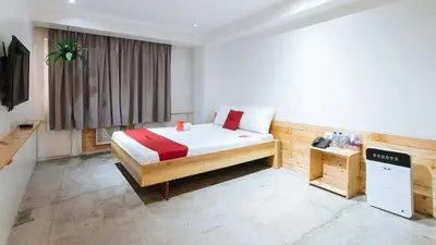 a bedroom with a bed and a television in a room at RedDoorz Plus at Boni Avenue Mandaluyong in Manila