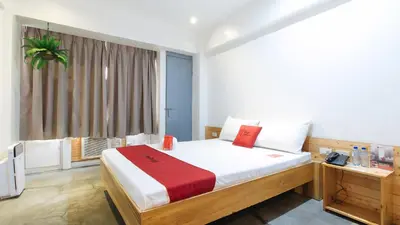 a bedroom with a large bed with white and red sheets at RedDoorz Plus at Boni Avenue Mandaluyong in Manila