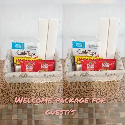 two baskets filled with packets of toothbrushes and toothpaste at Cozy 1BR-Grace Residences in Manila