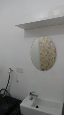a bathroom with a mirror and a sink at Cozy 1BR-Grace Residences in Manila