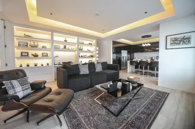 a living room with a couch and chairs and a table at The Alpha Suites in Manila