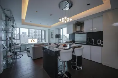 a kitchen with a island in the middle of a room at The Alpha Suites in Manila