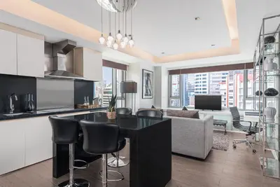 a kitchen and living room with a table and chairs at The Alpha Suites in Manila