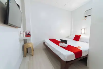 a bedroom with a bed and a tv in a room at RedDoorz at San Antonio Binan Laguna in Biñan