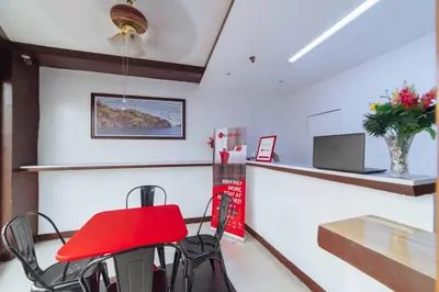 a bar with a red chair in a room at RedDoorz at San Antonio Binan Laguna in Biñan
