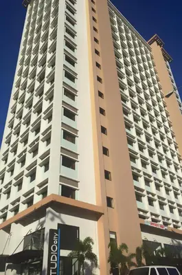 a tall building with a sign in front of it at Titan Condo at Studio City Tower 3 Alabang in Manila