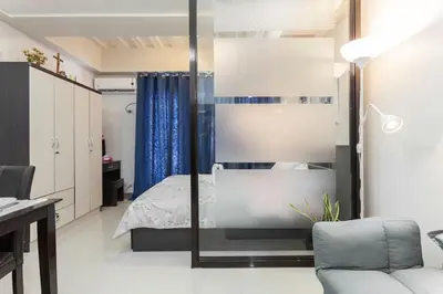 a bedroom with a bed and a mirror at Jen's Paranaque City Apartment in Manila