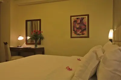 a hotel room with a bed and a desk with a desk at Armada Hotel Manila in Manila