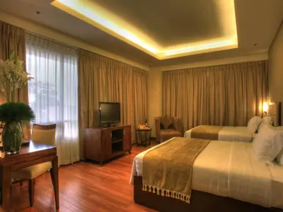 a hotel room with a bed and a television at Armada Hotel Manila in Manila