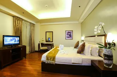 a hotel room with a bed and a television at Armada Hotel Manila in Manila