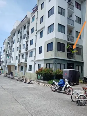 a motorcycle parked in front of a building at Spacious Studio unit beside Enchanted Kingdom at Santa Rosa City Laguna in Santa Rosa