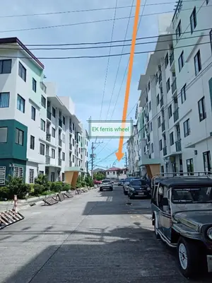 a car parked on the side of a street with buildings at Spacious Studio unit beside Enchanted Kingdom at Santa Rosa City Laguna in Santa Rosa