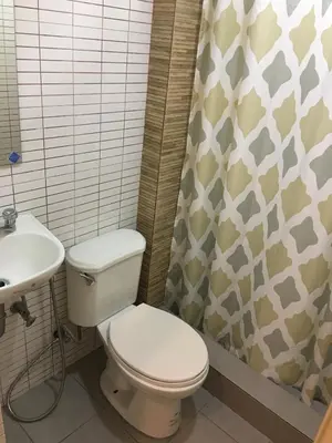 a bathroom with a toilet and a sink at 1 River Central Hostel in Manila