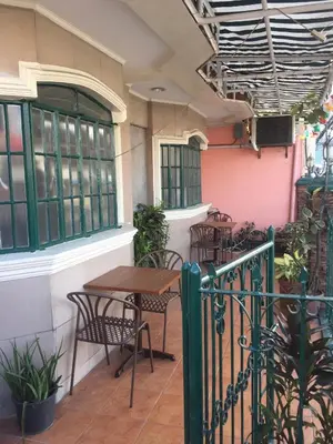 a patio with tables and chairs in a restaurant at 1 River Central Hostel in Manila