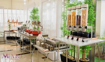 a store with several tables with plants on them at Ramada by Wyndham Manila Central in Manila