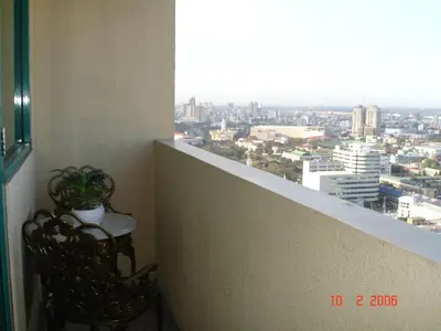 a balcony with a chair and a view of a city at 67 sqm. Condo Unit in Robinson Place Residences in Manila