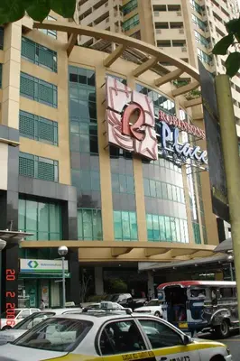 a large building with cars parked in front of it at 67 sqm. Condo Unit in Robinson Place Residences in Manila