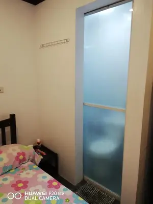 a sliding glass door in a bedroom with a bed at Diaz Residence in Silang