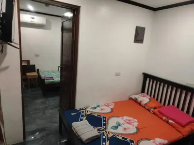 a bedroom with a bed and a mirror at Diaz Residence in Silang
