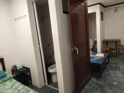 a bathroom with a toilet and a open door at Diaz Residence in Silang