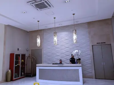 two men standing at a counter in a lobby at 1BR and Studio Condo Unit @ 150 Newport near NAIA 3 in Manila
