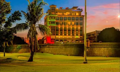 a building with a palm tree in front of it at The Bayleaf Intramuros in Manila