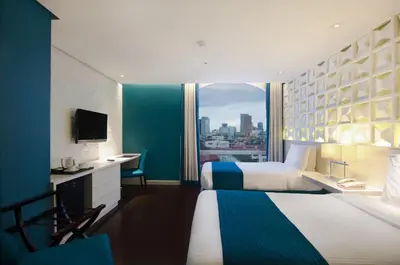 a hotel room with a large bed and a window at The Bayleaf Intramuros in Manila