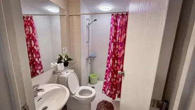 a bathroom with a toilet and a sink and a shower at Azure Urban Resort Maui Unit in Manila