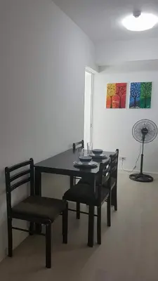 a dining table and chairs in a room at Azure Urban Resort Maui Unit in Manila