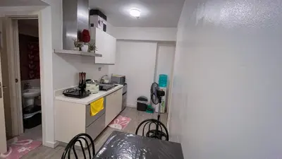 a small kitchen with a counter and a table and chairs at Azure Urban Resort Maui Unit in Manila