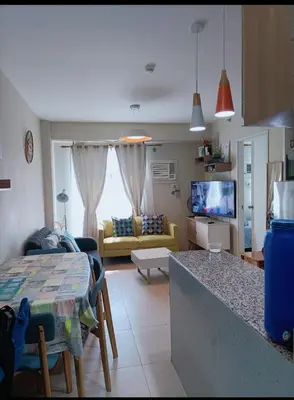 a kitchen and living room with a couch and a table at 2BR avida tower near NAIA airport in Manila
