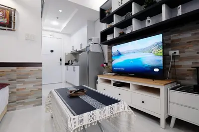 a living room with a flat screen tv on a counter at Lotus Residence, Manila in Manila