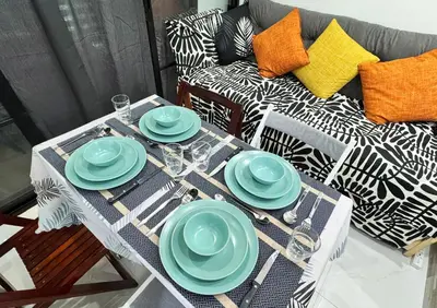 a table with blue plates on it with a couch at Lotus Residence, Manila in Manila