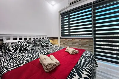 a bedroom with a large bed with towels on it at Lotus Residence, Manila in Manila