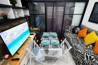 a living room with a table and a couch at Lotus Residence, Manila in Manila