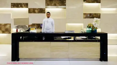 a man standing behind a counter in a room at Lotus Residence, Manila in Manila