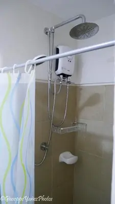 a shower with a shower head in a bathroom at Genesis unit SMDC Fields in Manila