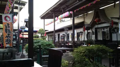 an outdoor restaurant with tables and chairs and signs at Amora Suites at the Beacon Makati in Manila