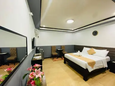 a bedroom with a bed in a room at Amax Inn Makati in Manila