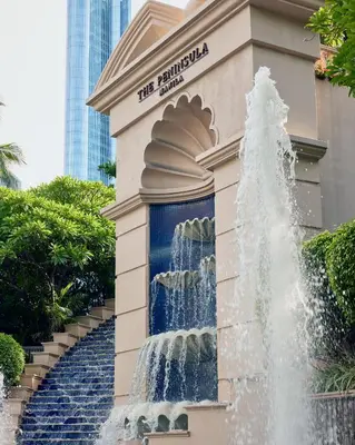 a water fountain in front of a building at The Peninsula Manila in Manila