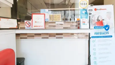 a store counter with signs on the top of it at RedDoorz near NAIA Terminal 1 in Manila
