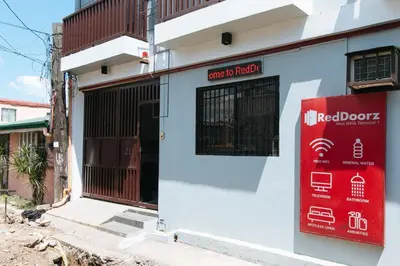 a building with a red door and a red sign at RedDoorz near NAIA Terminal 1 in Manila