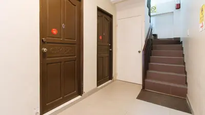 a corridor with two doors and stairs in a building at RedDoorz near NAIA Terminal 1 in Manila