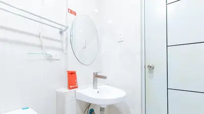 a white bathroom with a sink and a mirror at RedDoorz near NAIA Terminal 1 in Manila