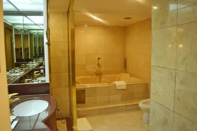 a bathroom with a tub and a toilet and a sink at Manila Prince Hotel in Manila