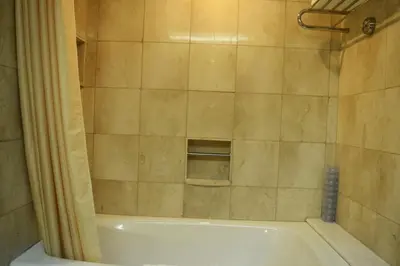 a bathroom with a shower and a bath tub at Manila Prince Hotel in Manila